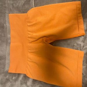 Sunset orange NVGTN biker shorts